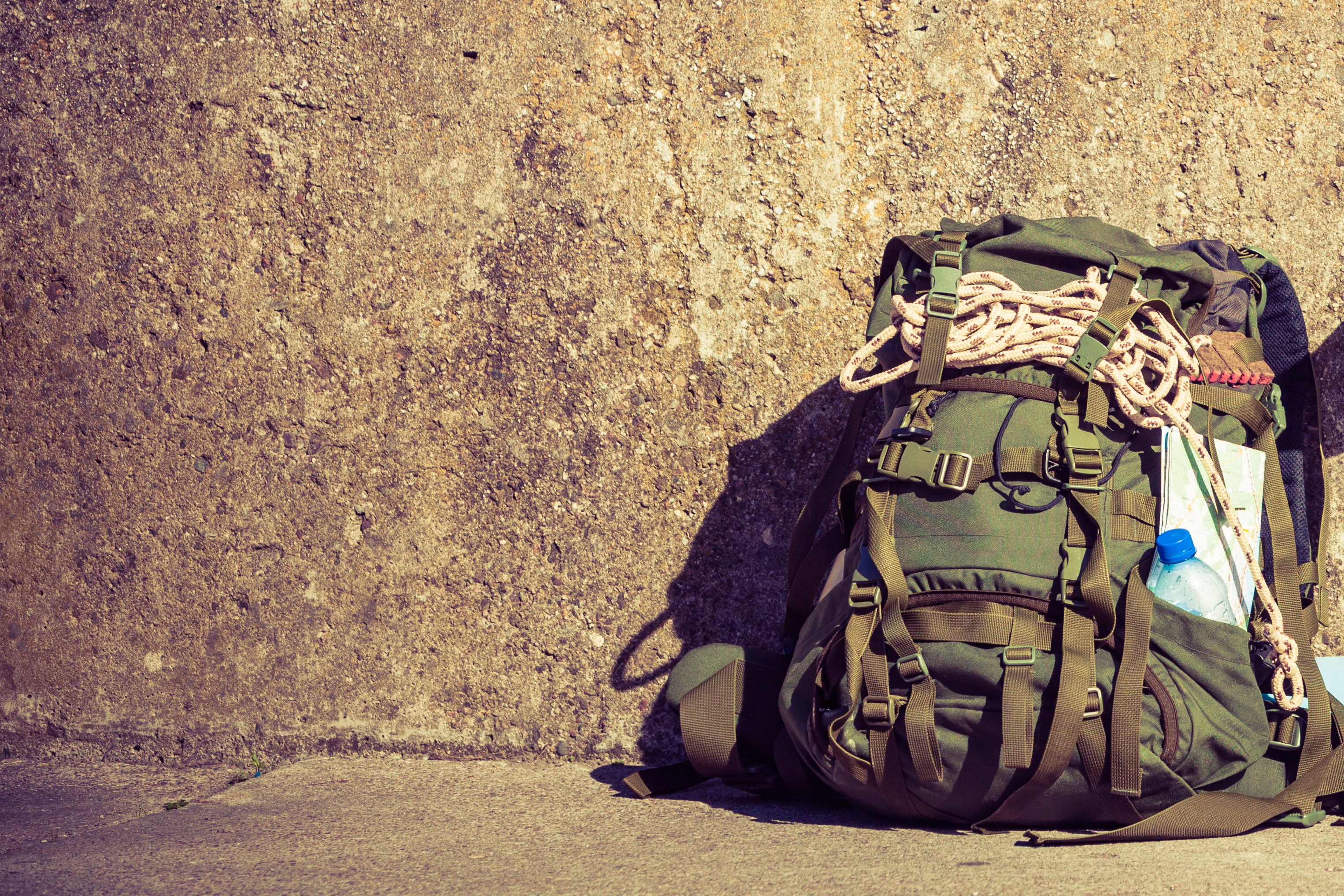 Hiking backpack camping equipment outdoor on grunge wall